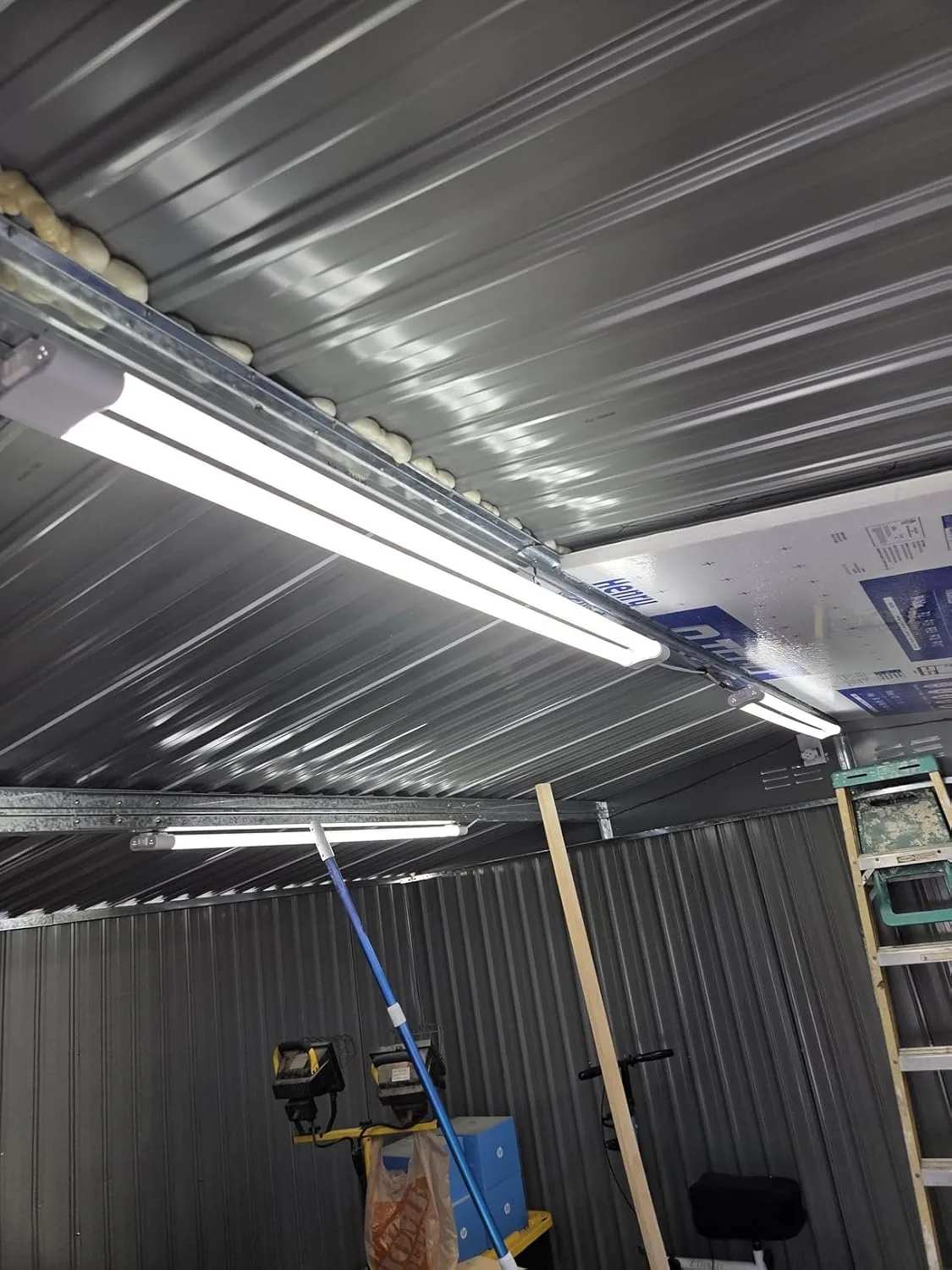 Customer photo of dust light mounted in workshop showing illumination over workbench area